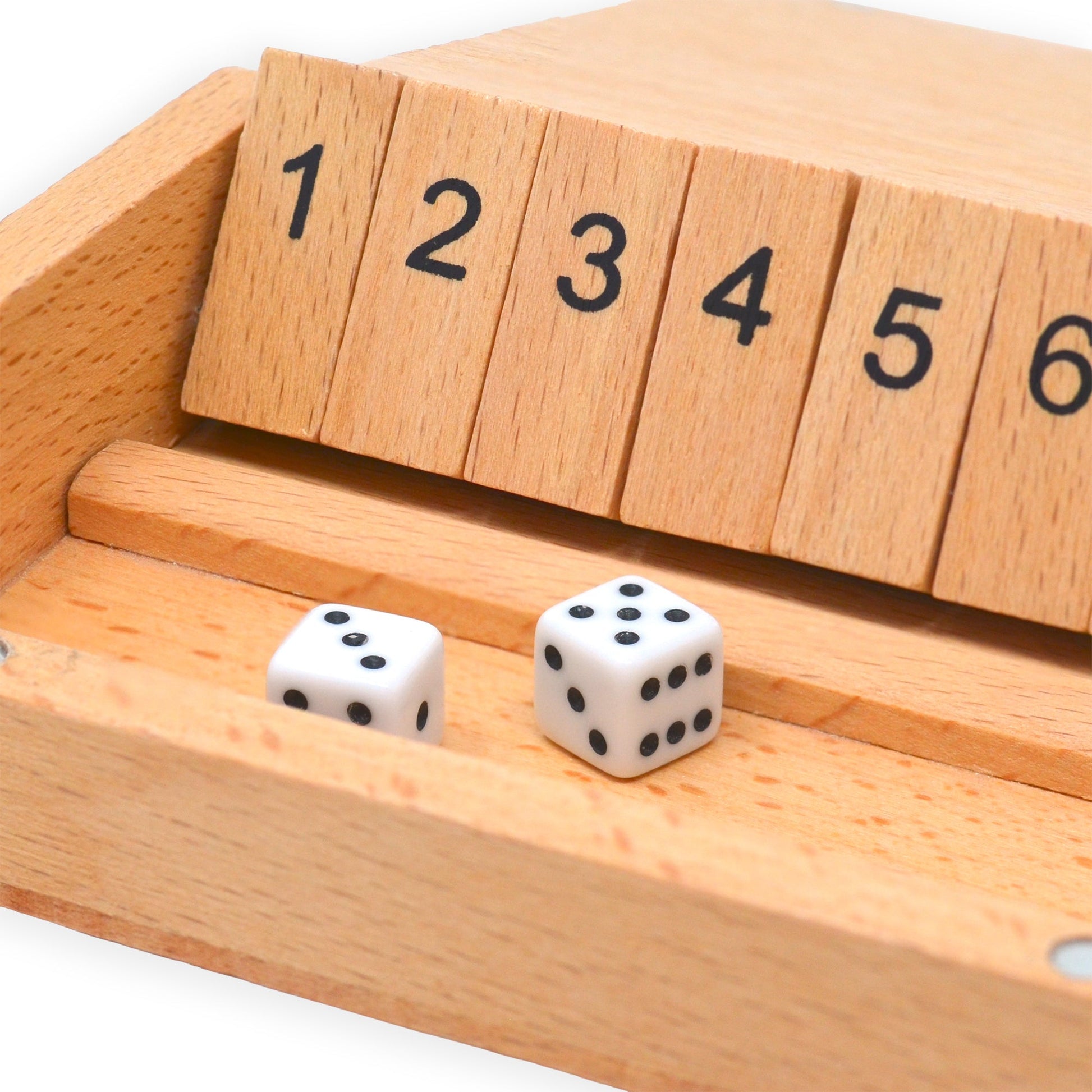 Detail close-up of an open Shut The Box Wooden Dice Game showing unflipped numbered tiles and two mini dice